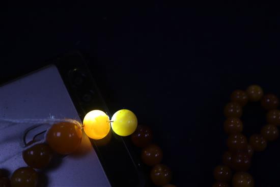 A single strand amber bead necklace, gross weight 28 grams and two other necklaces.